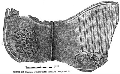 Black and white drawing of leather saddle fragment with floral and linear decorations.