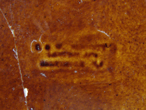 Detail of bottom of the pitcher showing a stamped manufacturer's mark reading E & W Bennett/Canton Avenue/Baltimore.