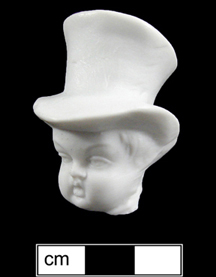 White porcelain head of a toddler wearing a large top hat.