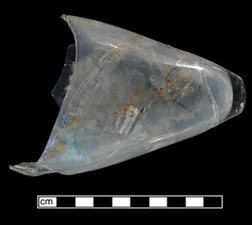 A glass bottle shaped like a torpedo, with a nipple at one end and a cork opening in the center.
