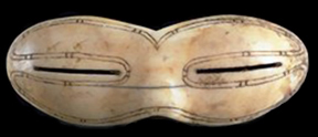 Carved bone snow goggles, with thin slits for eye holes.