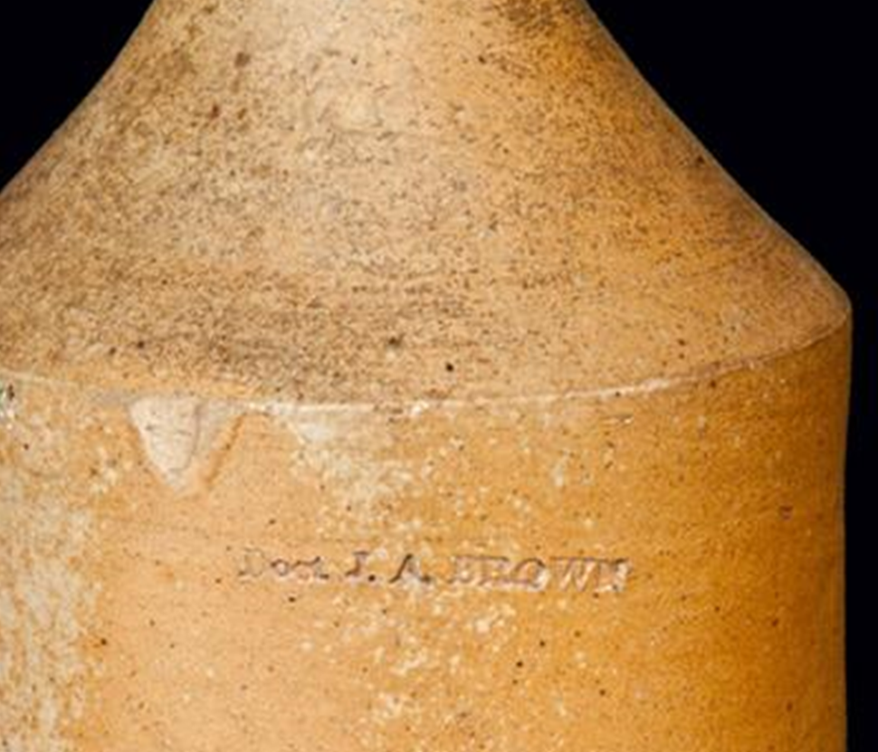 Detail shot of brown stoneware bottle shoulders and side with impressed mark Dr. J. A. Brown.