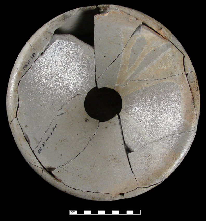 Top view of grey circular spittoon showing sloping sides and small hole where tobacco juice flows in.
