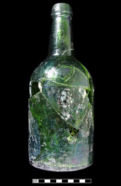 Emerald green glass bottle that has been broken and mended.