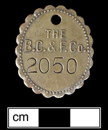 Oval shaped metal tag molded with letters 
