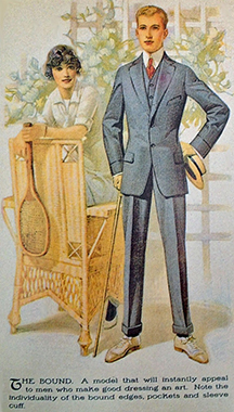 Nattily suited early 20th century young man standing with arms akimbo in front of a wicker chair and a young woman in tennis whites.