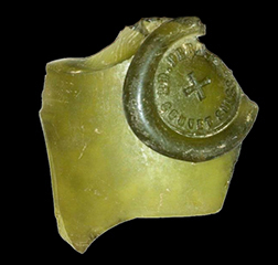 Fragment of a green absinthe bottle with a bottle seal.