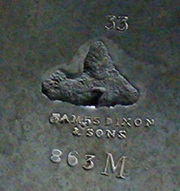 Figure 3 Macro photograph of a maker's mark on white metal reading 