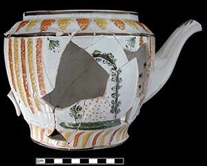 Reverse side of partial teapot depicting a woman reading.