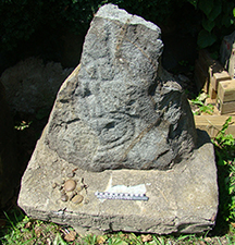Large stone fragment with a petroglyph present.
