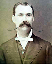 Late 19th-century photograph of a man with a handlebar mustache.