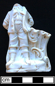 White porcelain vase molded in the shape of a boy standing beside a stump.