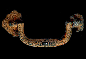 Intact metal Swingball coffin handle on a black background.