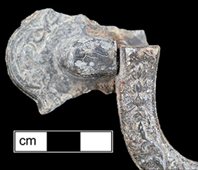 Close up photograph of corrosion on a coffin handle.