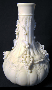 Photograph of detail of small grape cluster on porcelain bottle.