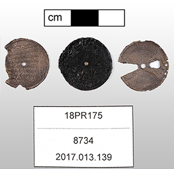 Three metal disks, two copper alloy and one iron, that make up the workings of a 