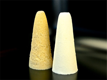 Two side-by-side sugar cones--one white sugar and the other brown sugar.