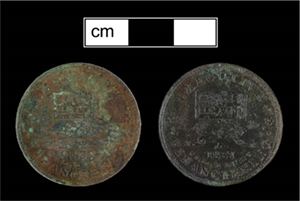 Front and back image of a coin on a black background with a centimeter scale.