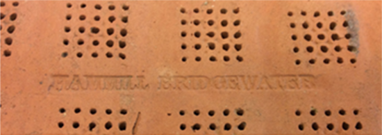 Detail of a portion of a malting tile showing a stamped mark of the Hammill Company.