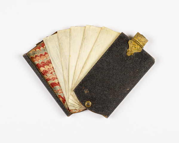 Historic example of a complete aide-memoire booklet with dark exterior, marbled paper lining, and at least 5 sheets of ivory to act as pages. 