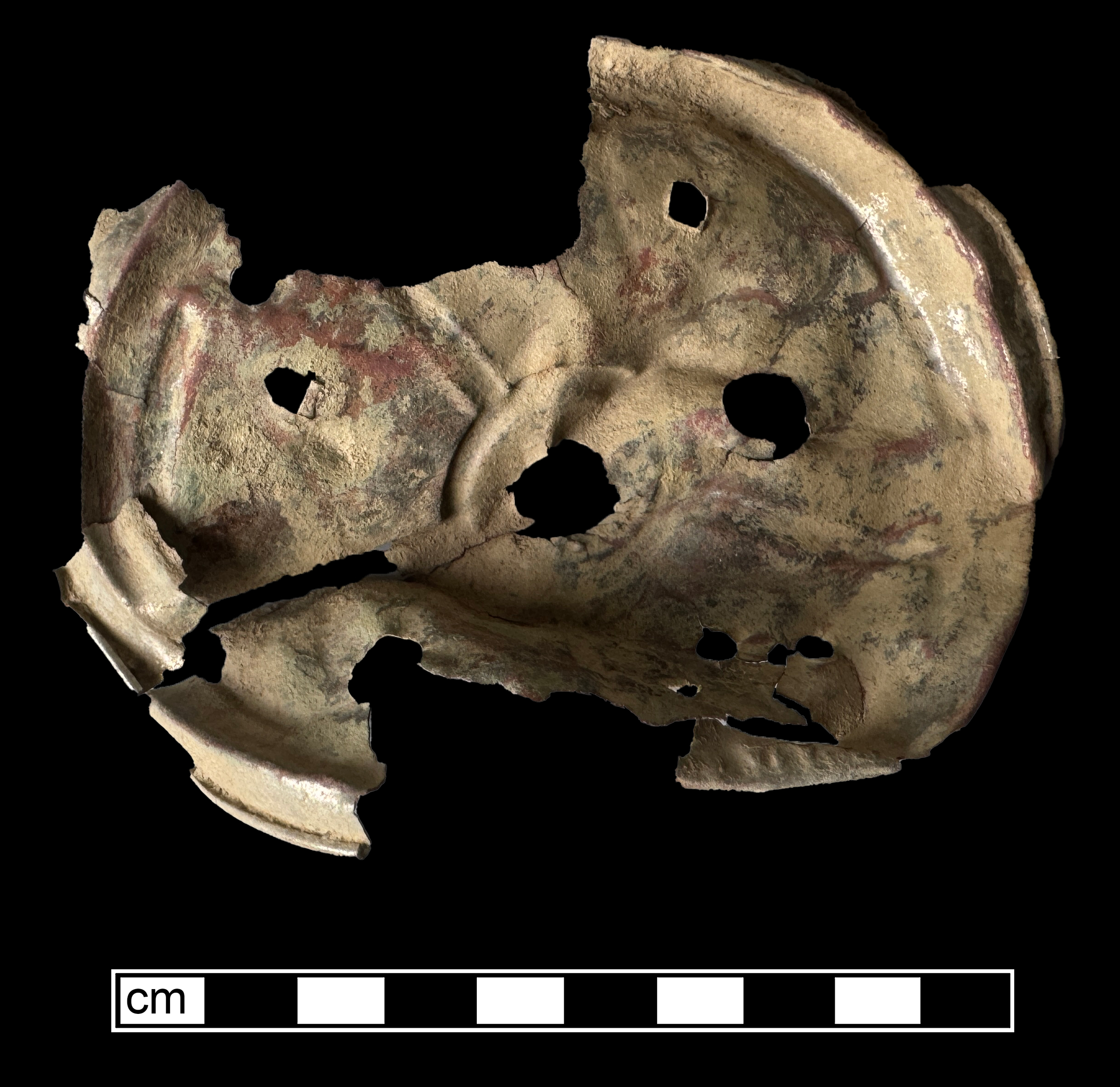 Round bent piece of thin metal with spoke-like supports, a hole in the middle, and several small holes spread throughout.