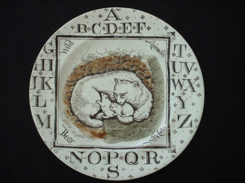 Circular plate with letters of the alphabet printed in brown around the rim.  The center of the plate has a color image of a white bear with two cubs and the words “Bear with Cubs”.