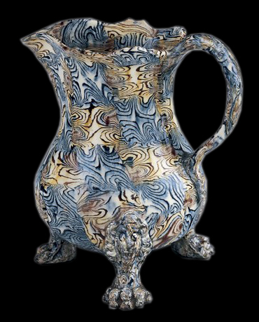 Lead-glazed agateware cream jug, Staffordshire, ca. 1750.  H. 10". The body of this jug was formed in a two piece press mold.  (Chipstone Foundation.) 