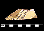 North Devon Sgraffito dish with incised indeterminate motif, probably floral. White slip over red earthenware body, with lead glazed interior.  