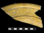 North Devon Sgraffito dish with incised spiral (curlicue) motif. White slip over red earthenware body, with lead glazed interior. Approximately 12” rim diameter. Lots 61, 106. Rim and interior incised motifs similar to Vessel 26 depicted in Grant (1983), from a context of circa 1665 and to examples from a circa 1670-1680 context at Jamestown, Virginia.