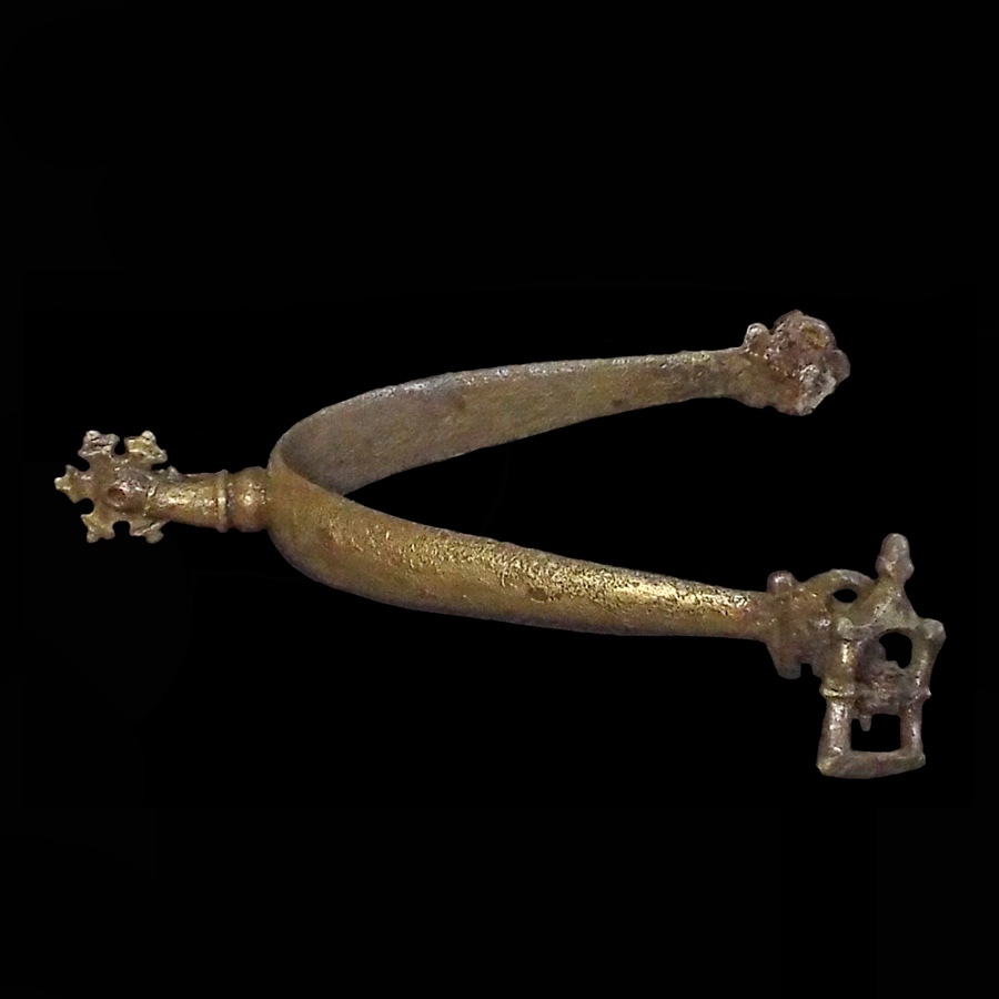 Image of copper alloy spur with iron stud hangers and copper alloy studs.
