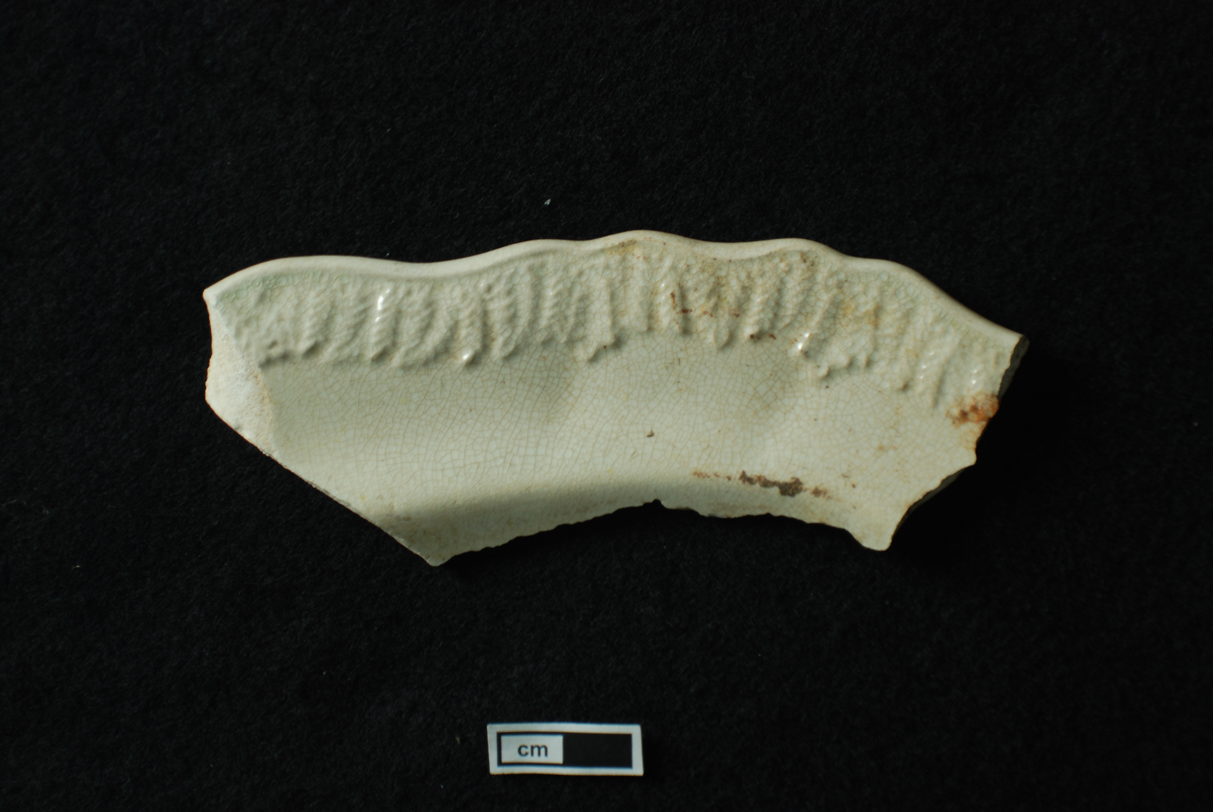 Image of edged earthenware fragment.