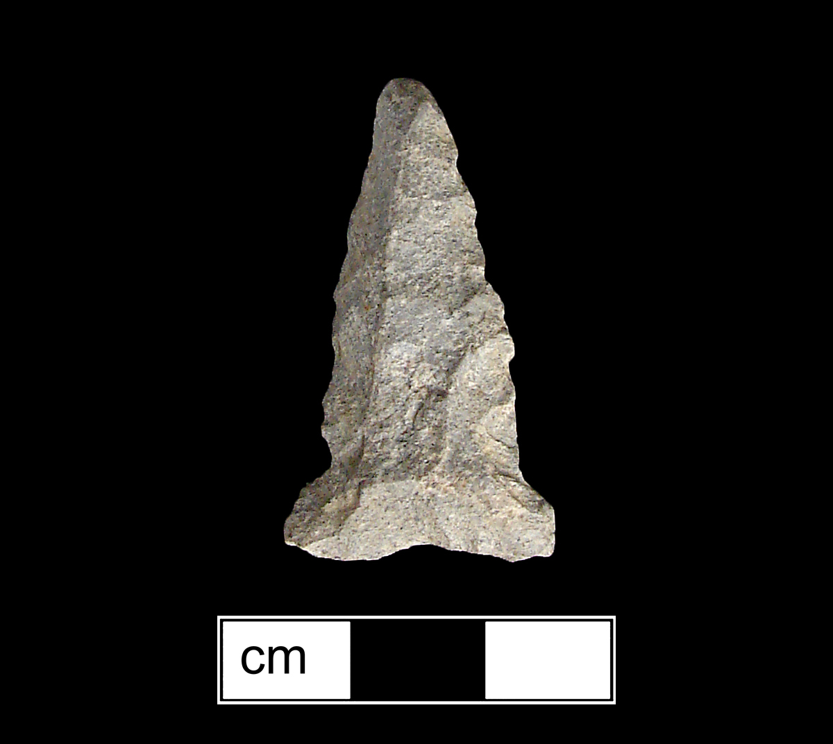 Image of stone projectile point made of Rhyolite, Triangular shape, with a Expanding stem, Straight blade, and Concave base shape. Brewerton Eared Triangle type.