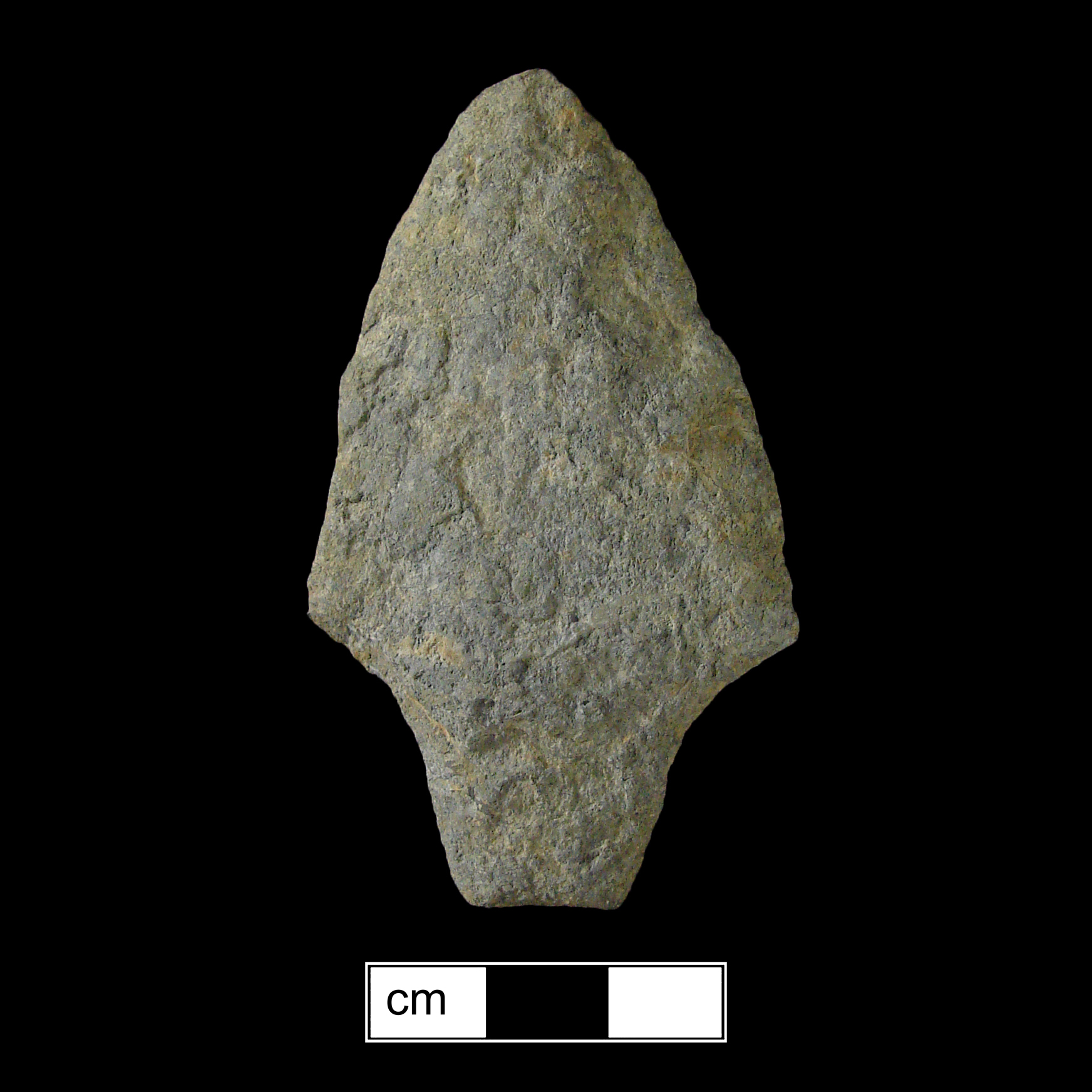 Image of stone projectile point made of Metarhyolite, Contracting Stem shape, with a Contracting stem, Excurvate blade, and Straight base shape. Lehigh/Koens-Crispin type.