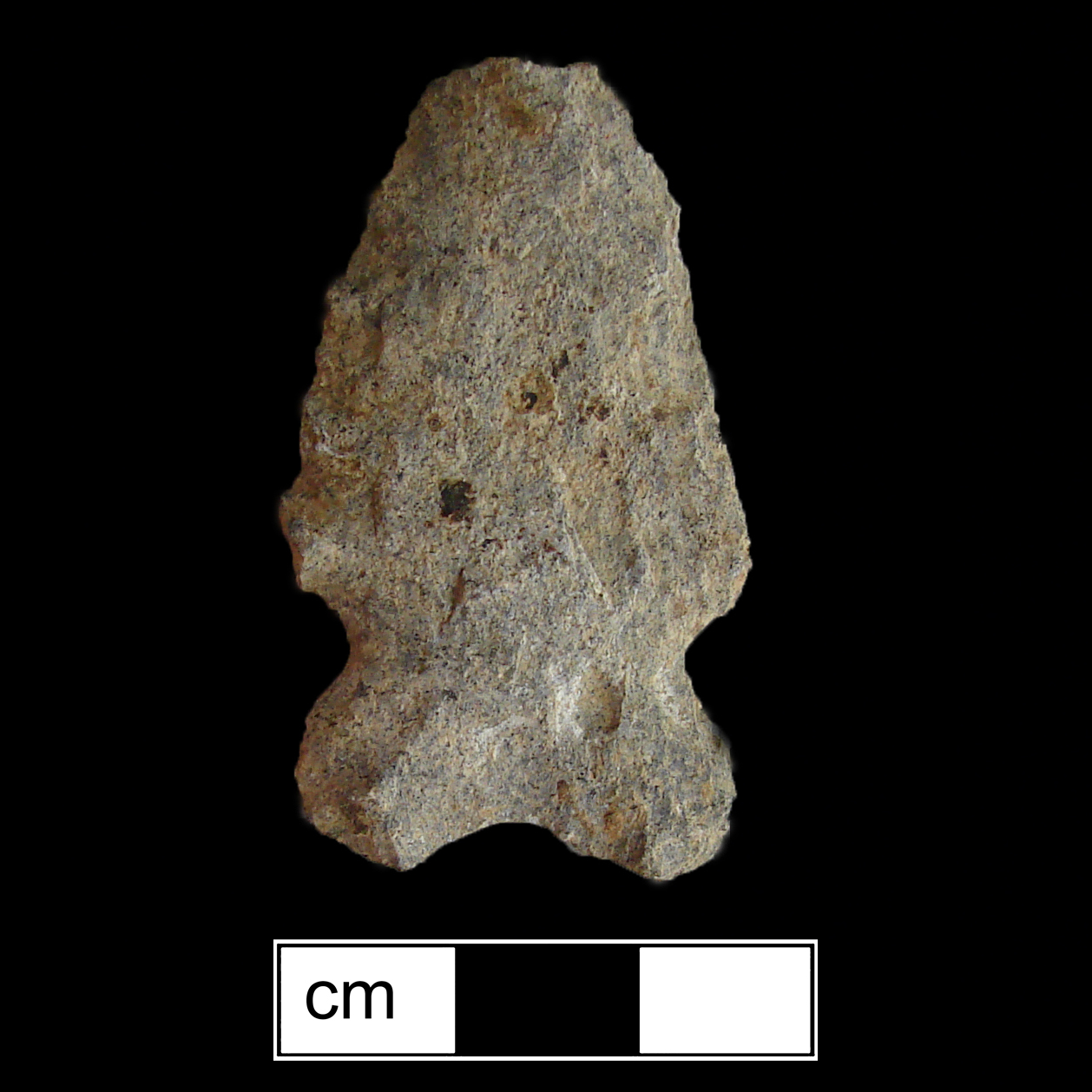 Image of stone projectile point made of Rhyolite, Bifurcate shape, with a Expanding stem, Straight blade, and Bifurcate base shape. MacCorkle type.