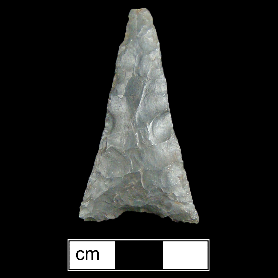 Image of stone projectile point made of Chert, Triangular shape, with a N/A stem, Straight blade, and Concave base shape. Madison type.