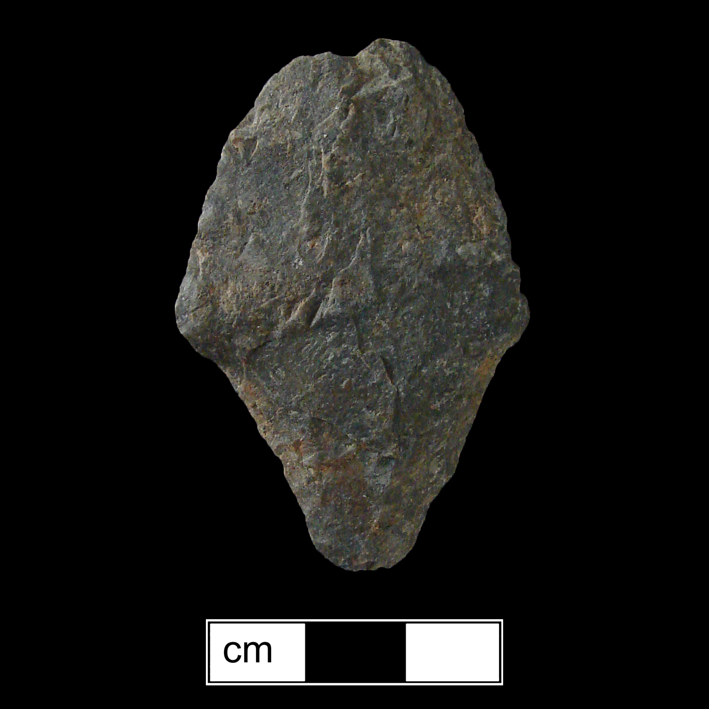 Image of stone projectile point made of Rhyolite, Contracting Stem shape, with a contracting stem, Excurvate blade, and Convex base shape. Morrow Mountain type.