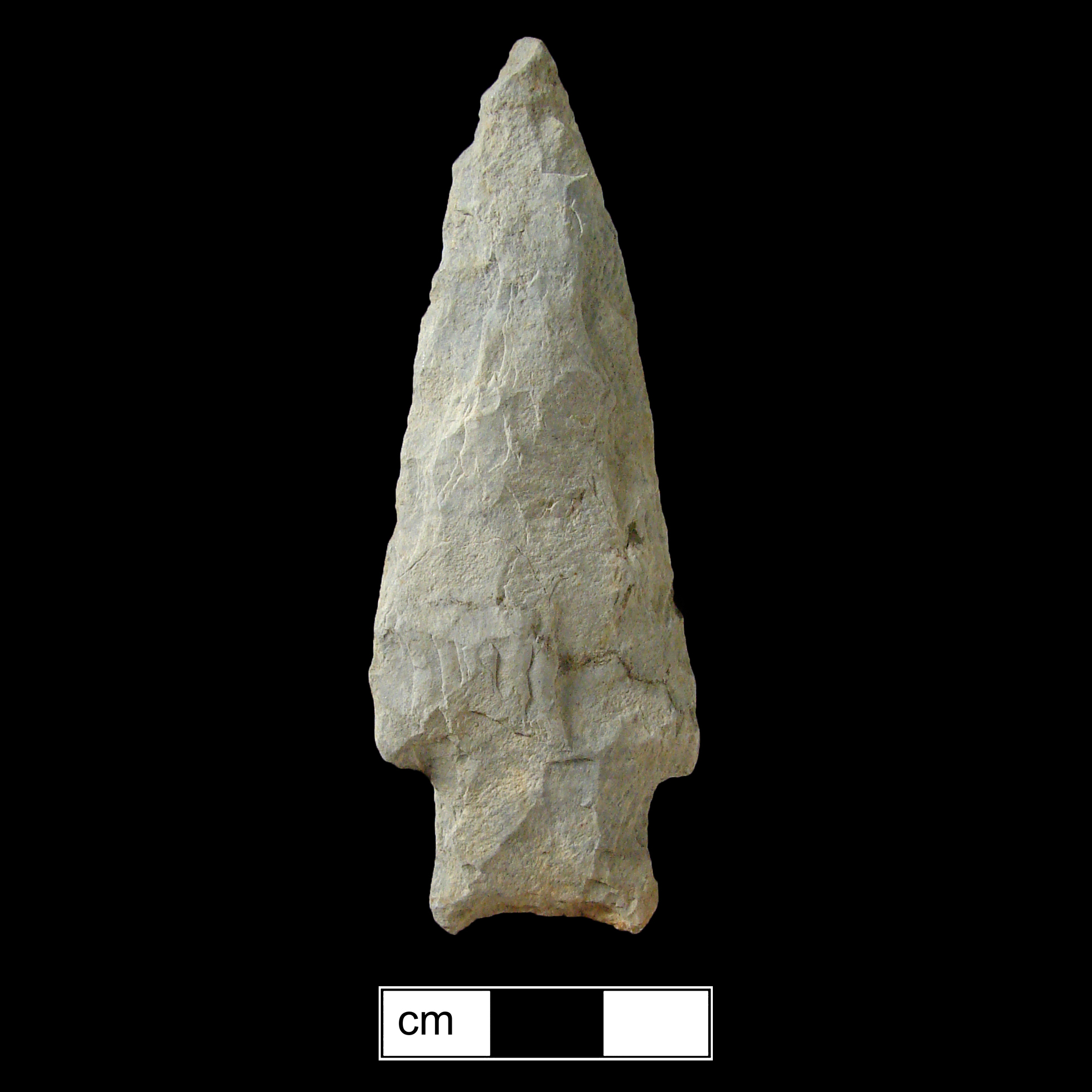 Image of stone projectile point made of Rhyolite, Stemmed shape, with a Straight stem, Straight blade, and Concave base shape. Savannah River type.