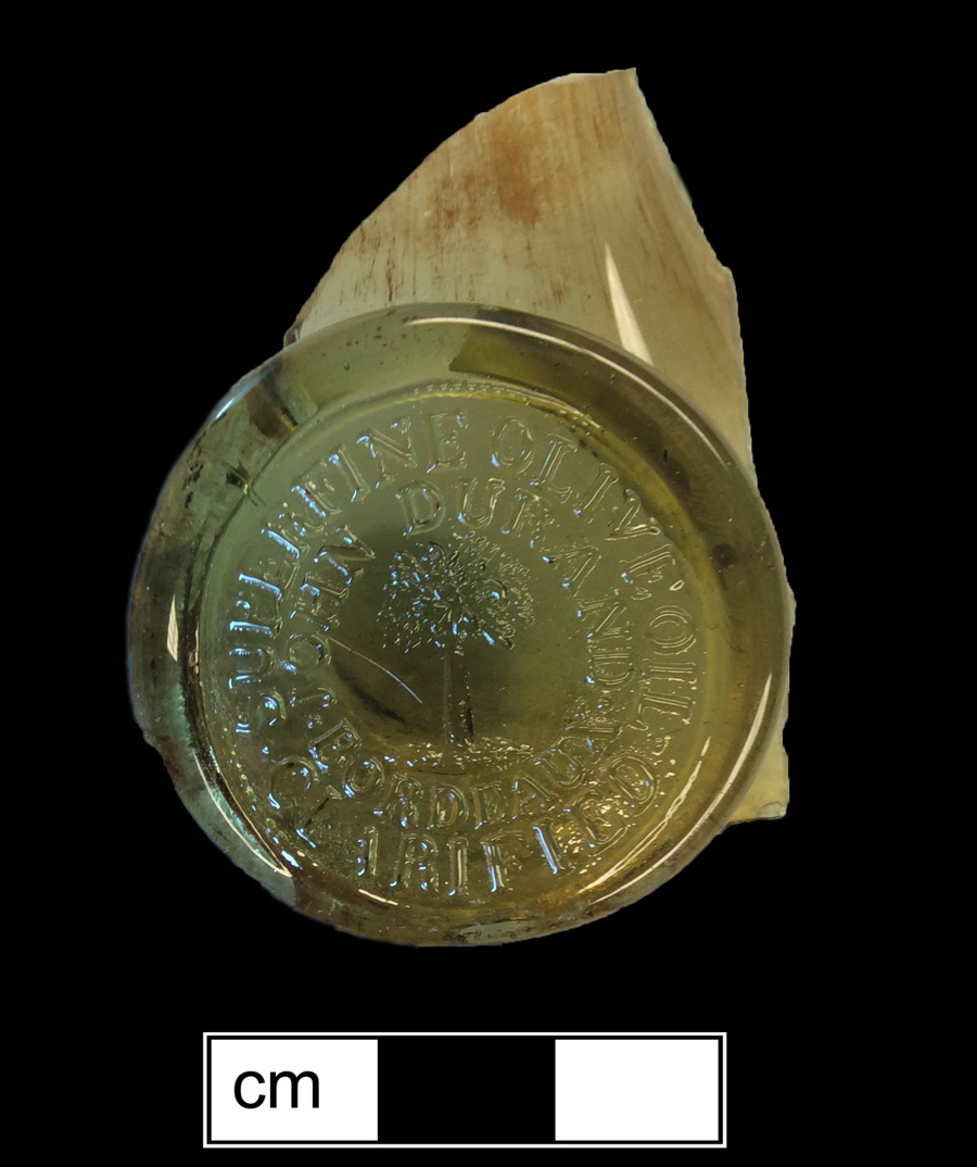 Image of colored glass bottle seal, Commercial Mark.