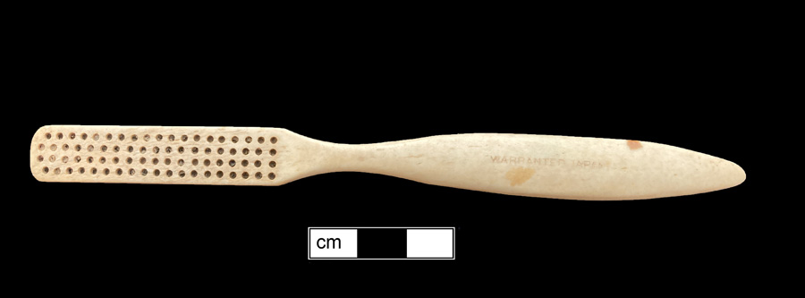 Image of bone toothbrush handle, trepanned, Georgia type.