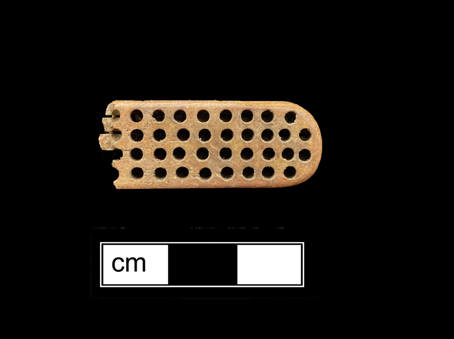 Image of bone toothbrush handle, wire drawn.
