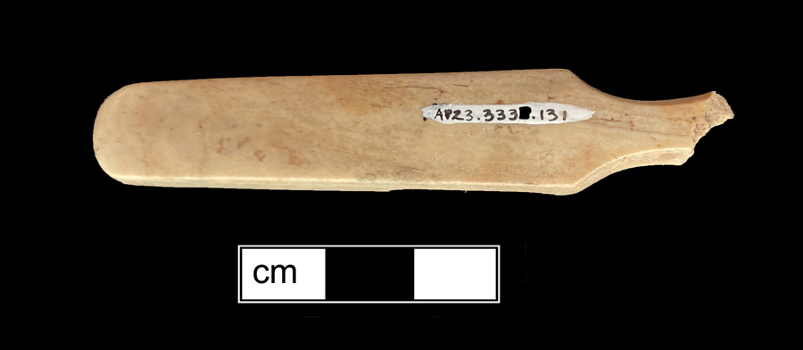 Image of bone toothbrush handle, trepanned.