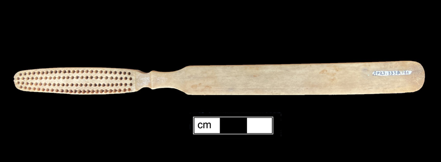 Image of bone toothbrush handle, trepanned, Illinois type.