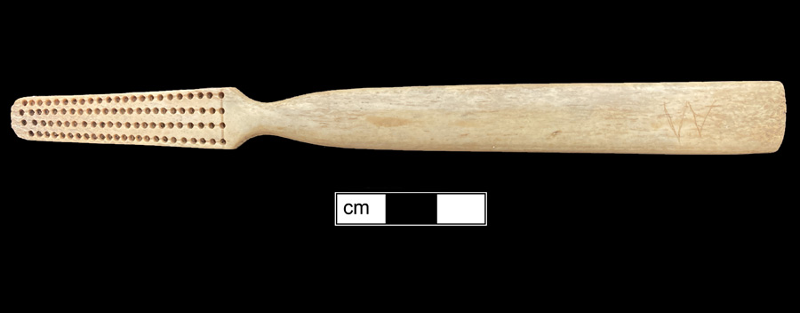 Image of bone toothbrush handle, trepanned, Virginia type.