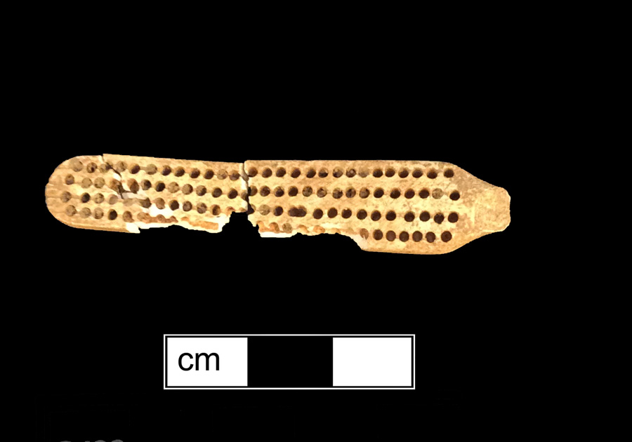 Image of bone toothbrush handle, trepanned.