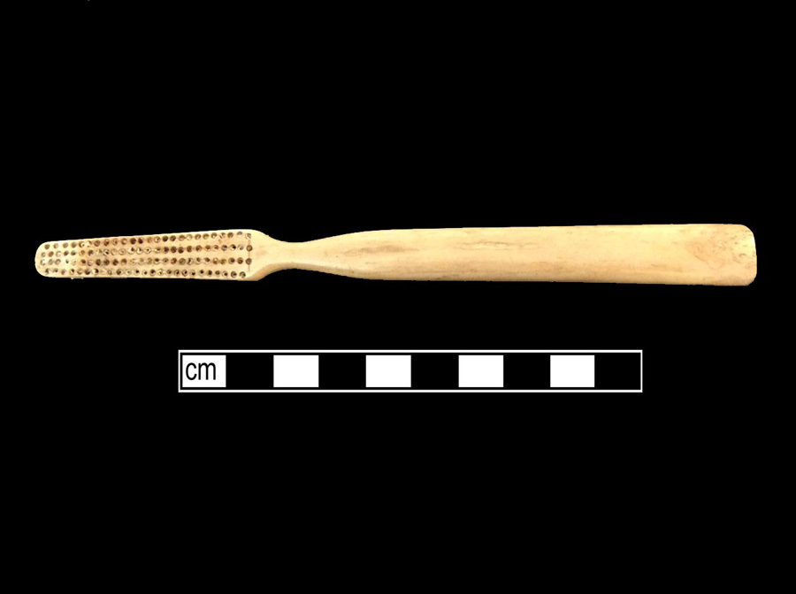 Image of bone toothbrush handle, trepanned, Virginia type.