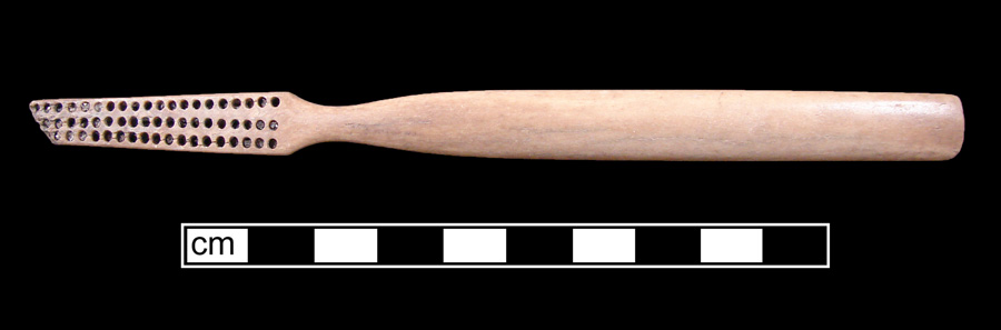 Image of bone toothbrush handle, trepanned, Virginia type.
