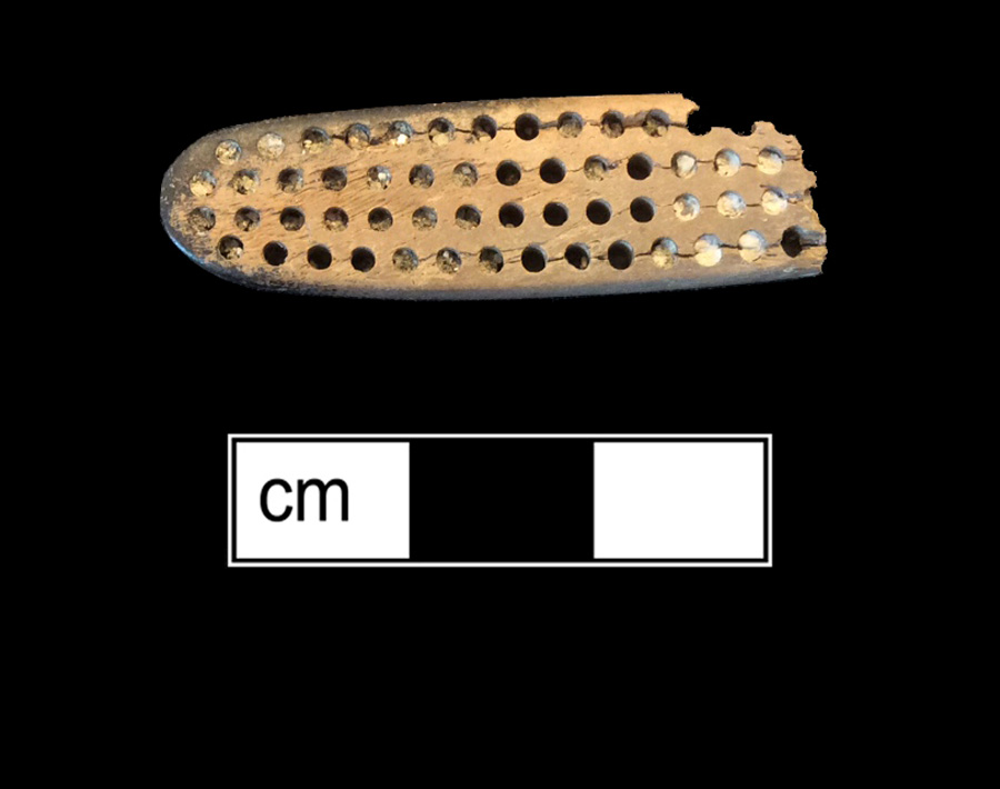 Image of bone toothbrush handle, trepanned.