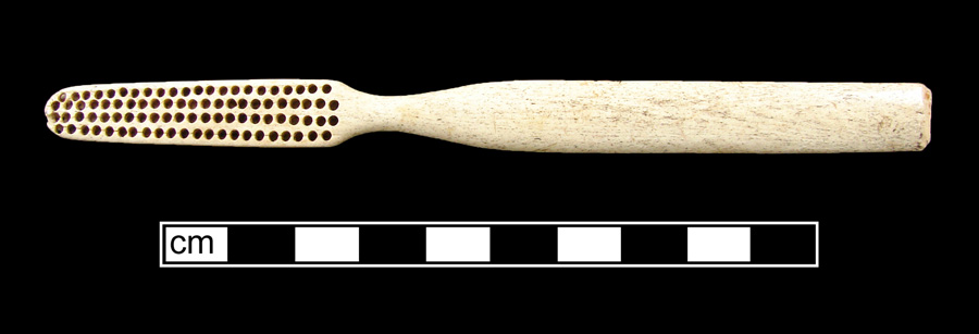 Image of bone toothbrush handle, trepanned, Virginia type.