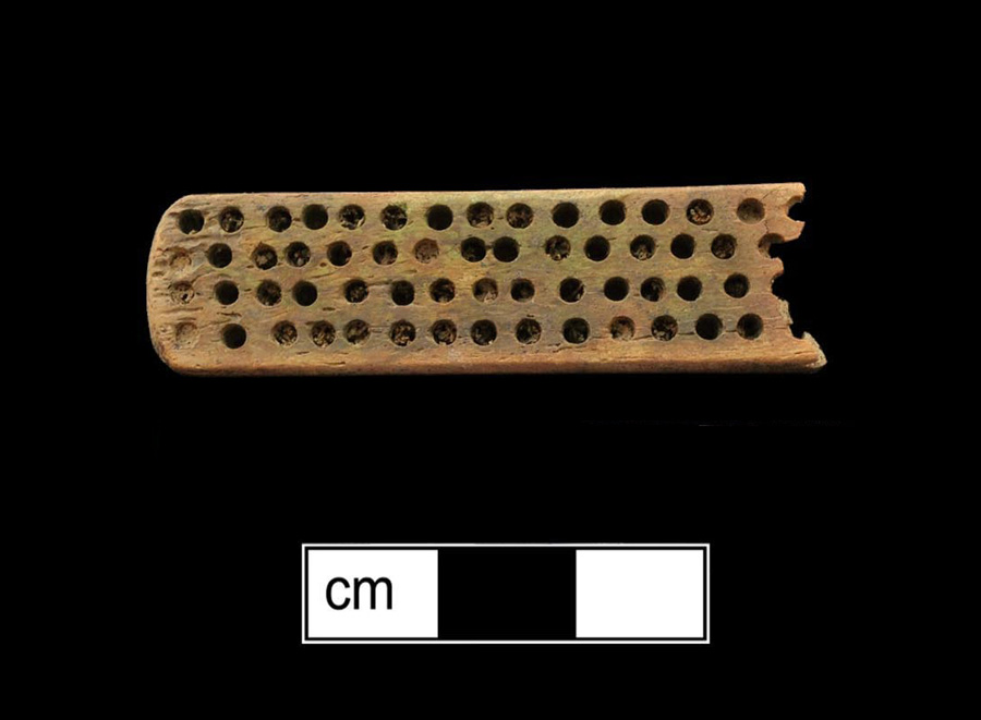 Image of bone toothbrush handle, wire drawn.