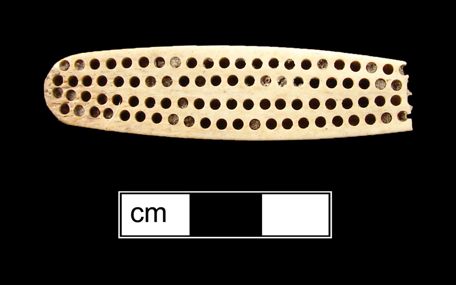Image of bone toothbrush handle, trepanned.